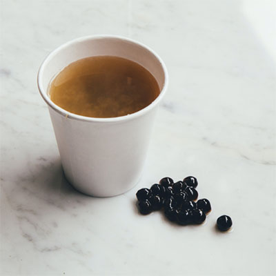 Cup of tea and tapioca pearls on table